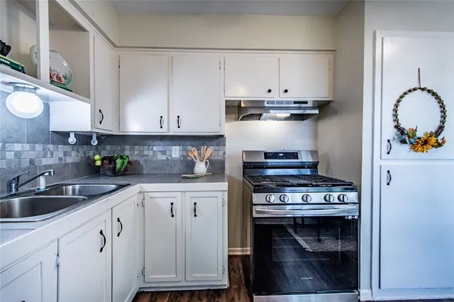 a kitchen with stainless steel appliances granite countertop a stove and a sink
