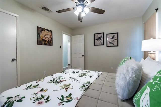 a bedroom with a bed and a chandelier