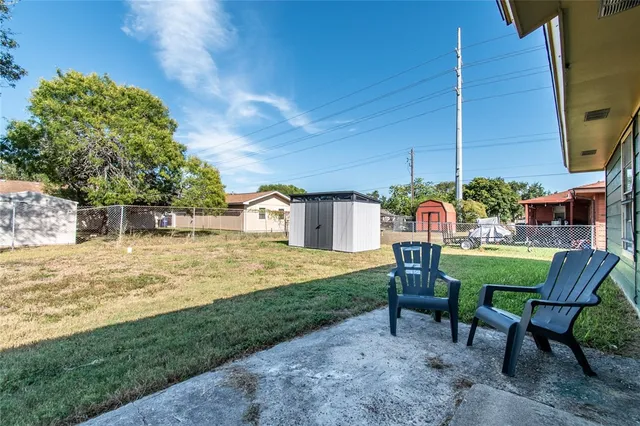 a view of a chairs and table in backyard of the house