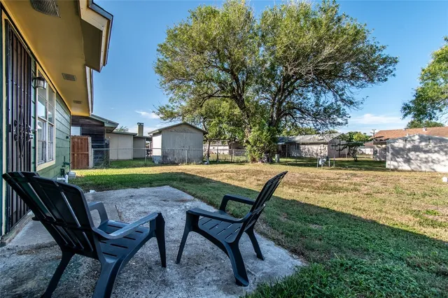 a view of a house with backyard swimming pool and sitting area
