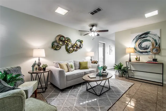 a living room with furniture a chandelier and a mirror