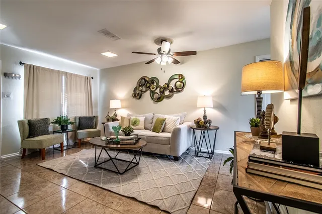 a living room with furniture a lamp and a lamp