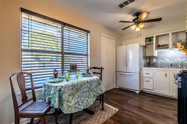 a dining room with furniture and wooden floor