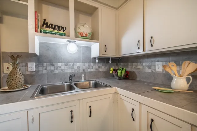 a kitchen with stainless steel appliances granite countertop a sink a stove and cabinets