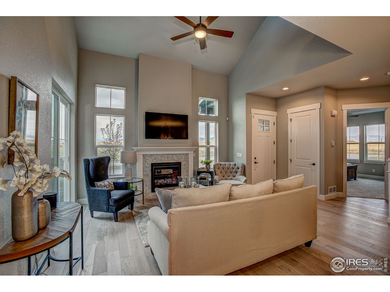 1547 Stoneseed Street Berthoud, CO 80513 - Photo 15 of 39 a living room with furniture a fireplace and a flat screen tv