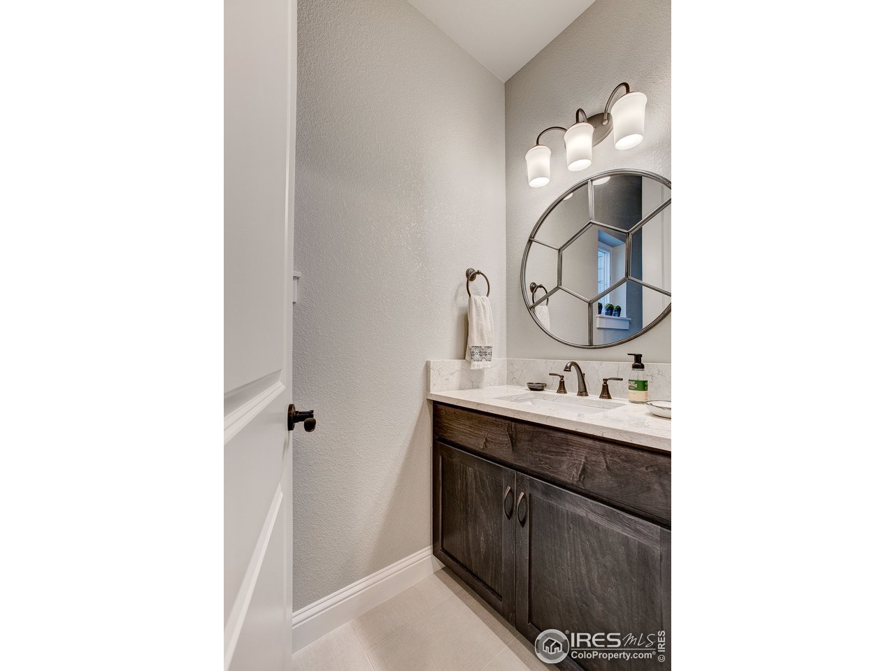 1547 Stoneseed Street Berthoud, CO 80513 - Photo 29 of 39 a bathroom with a sink and a mirror