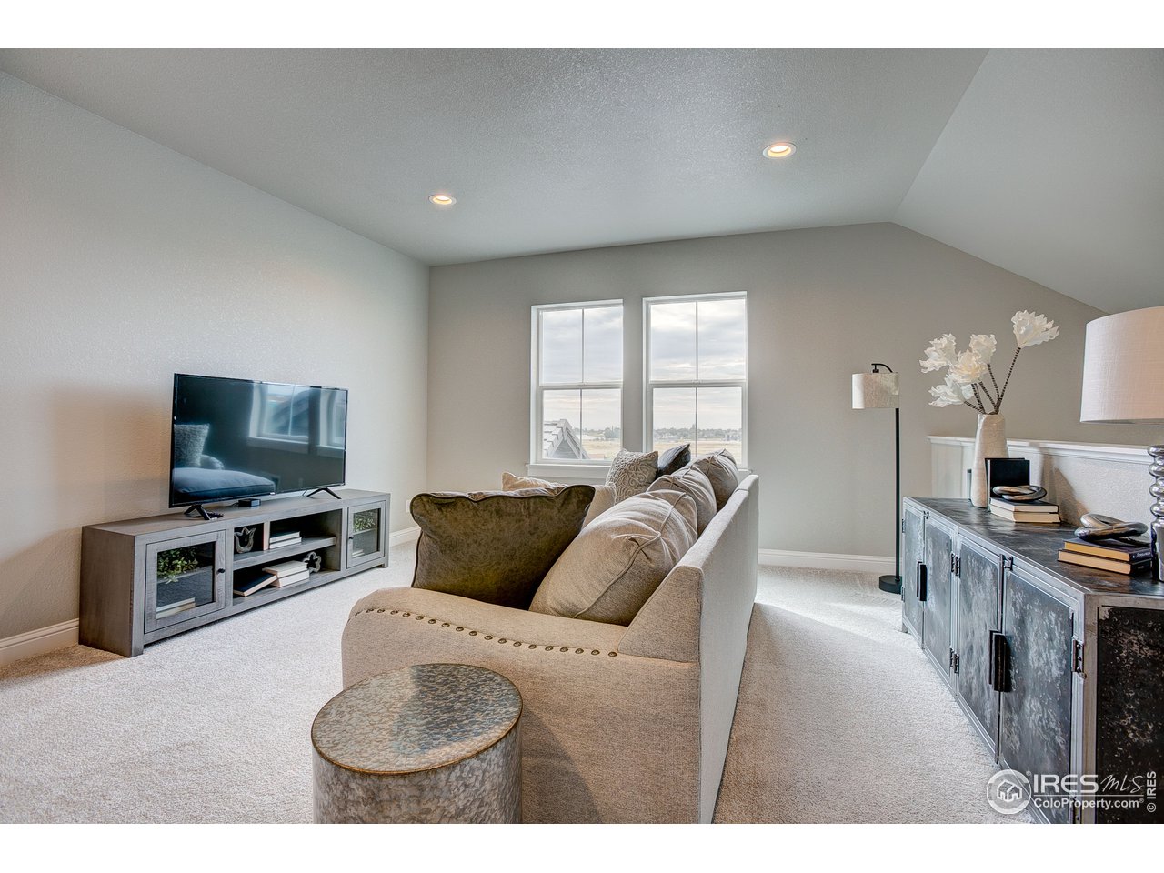 1547 Stoneseed Street Berthoud, CO 80513 - Photo 34 of 39 a living room with furniture and a flat screen tv