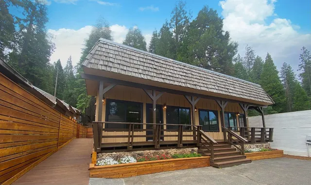 a view of a house with backyard porch and sitting area