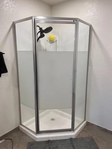 a view of a house with backyard and wooden fence