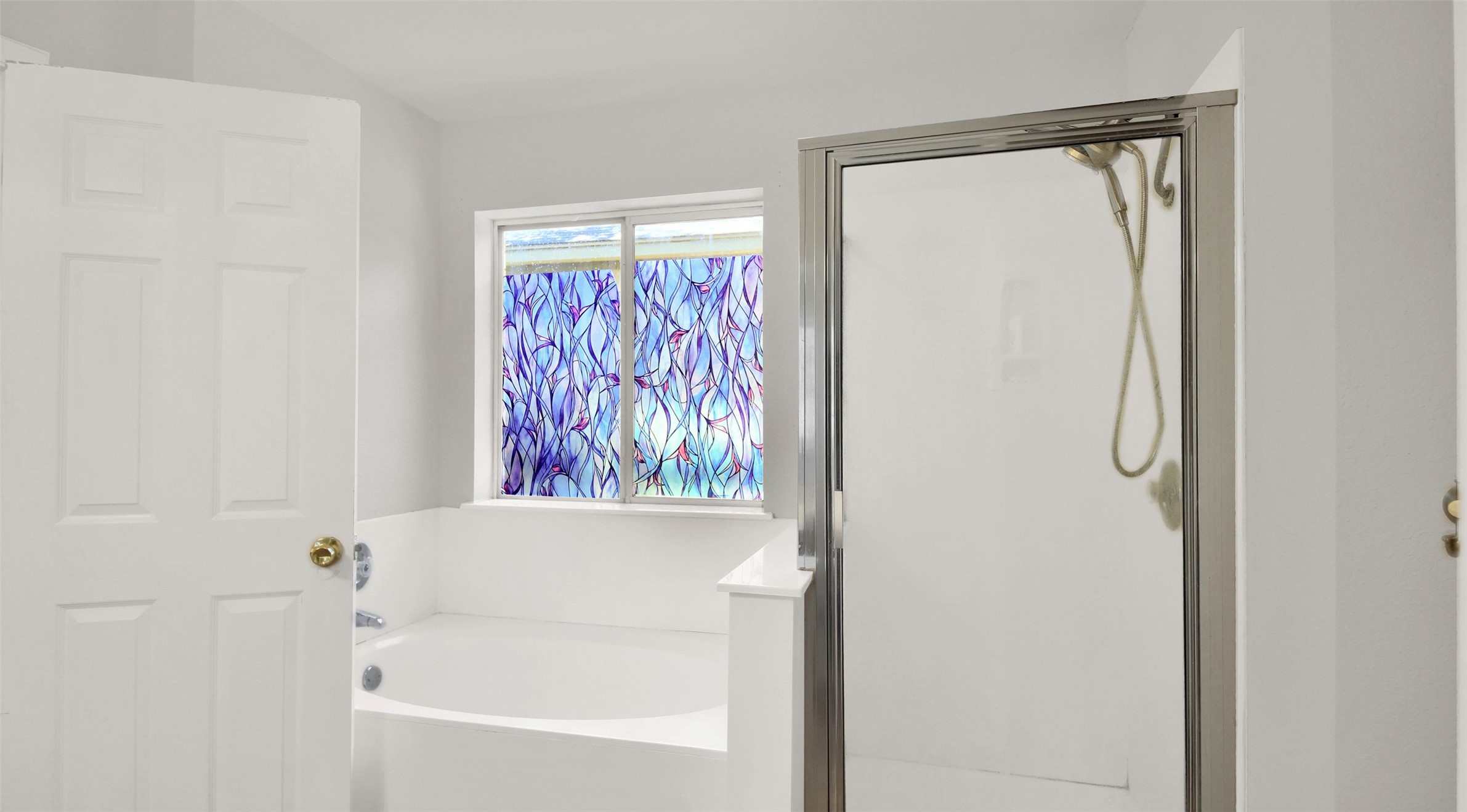 1609 Harness Raceway Street Pflugerville, TX 78660 - Photo 27 of 32 A window-lit bathroom offers a relaxing soaking tub and a separate glass-enclosed shower.