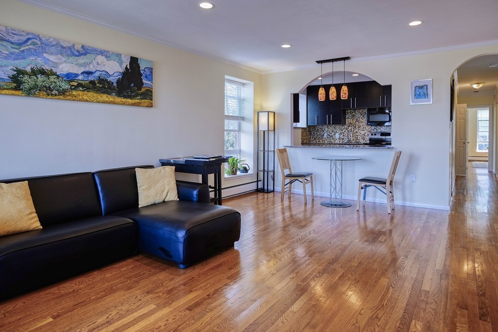 16 Addington Road, Unit 41 Brookline, MA 02445 - Photo 1 of 18 a living room with furniture and a wooden floor