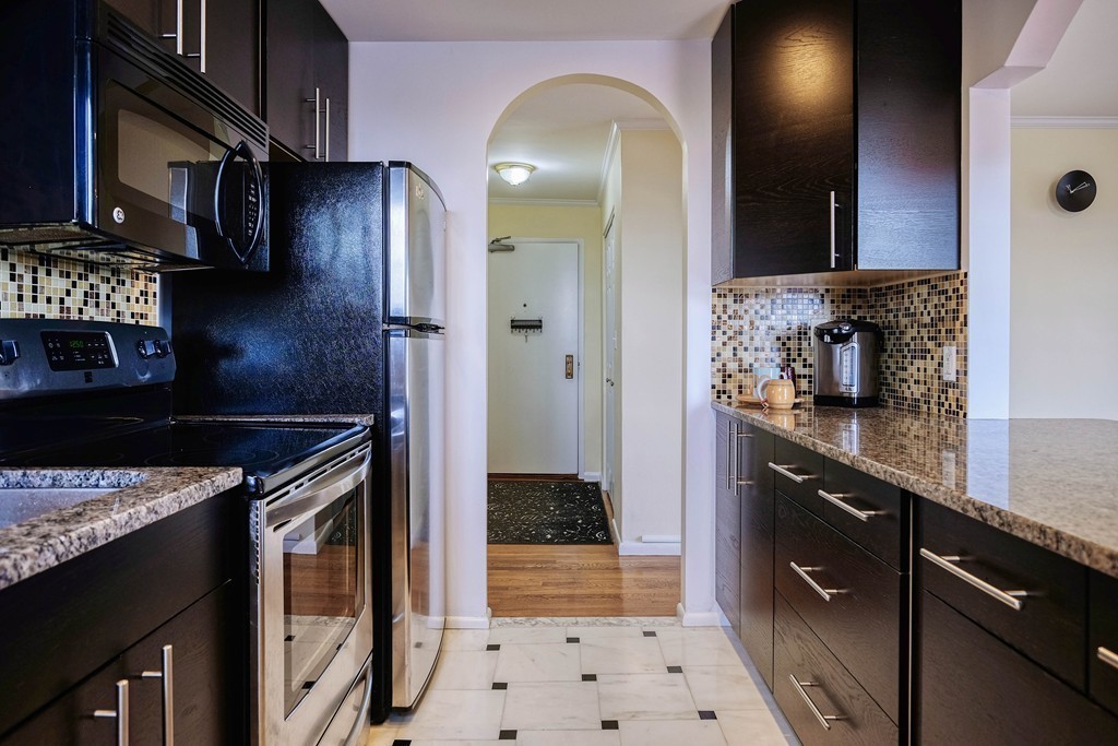 16 Addington Road, Unit 41 Brookline, MA 02445 - Photo 14 of 18 a kitchen with stainless steel appliances granite countertop a stove a sink and a microwave