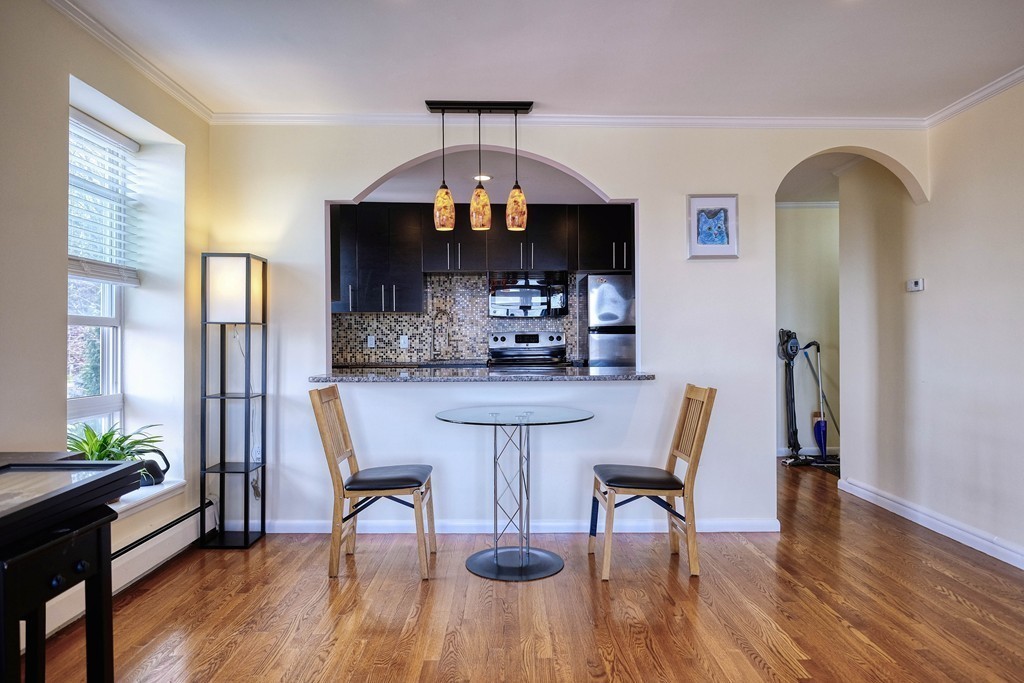 16 Addington Road, Unit 41 Brookline, MA 02445 - Photo 2 of 18 a dining room with furniture and wooden floor