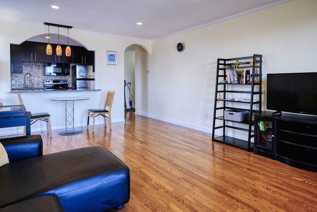 16 Addington Road, Unit 41 Brookline, MA 02445 - Photo 5 of 18 a living room with furniture and a flat screen tv