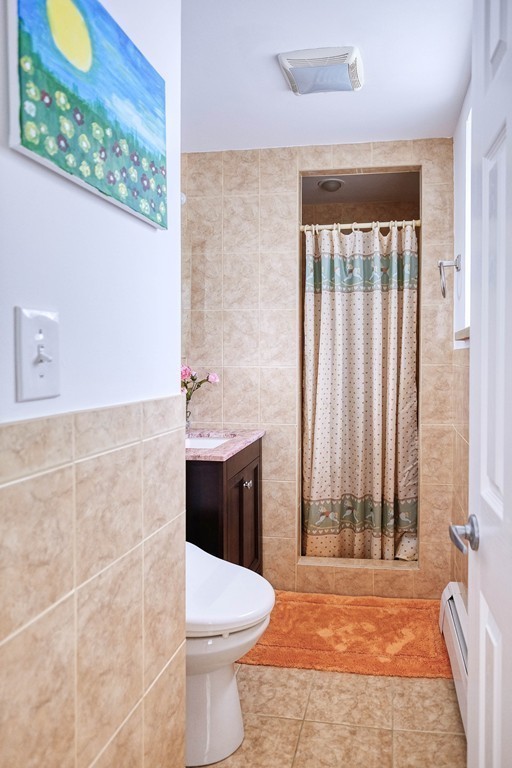 16 Addington Road, Unit 41 Brookline, MA 02445 - Photo 8 of 18 a bathroom with a toilet a sink and a shower