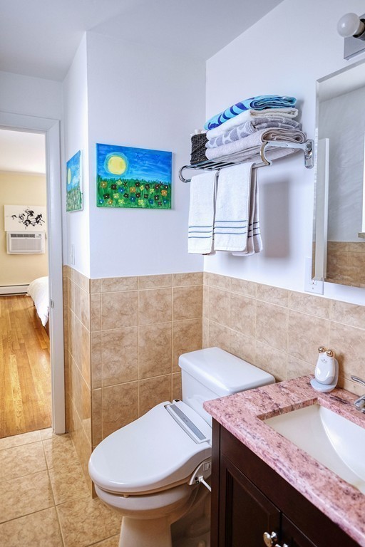 16 Addington Road, Unit 41 Brookline, MA 02445 - Photo 9 of 18 a bathroom with a sink toilet and mirror