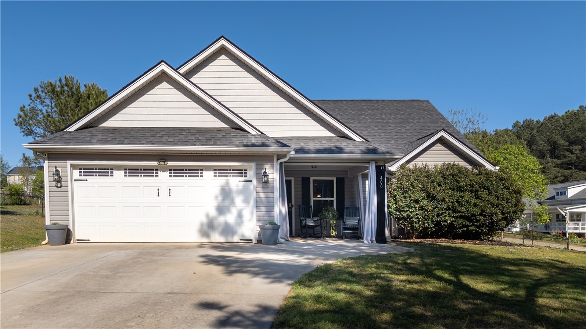 400 Green View Court Westminster, SC 29693 - Photo 2 of 33 This charming home features a practical attached garage and a welcoming covered porch, perfect for enjoying quiet mornings.