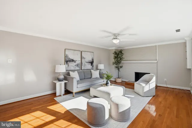 a living room with furniture a fireplace and a chandelier