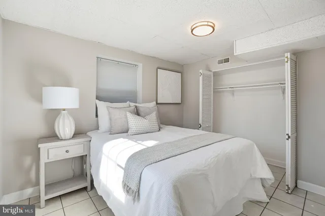 a bedroom with a bed and a lamp