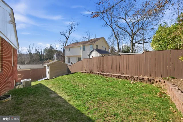 a view of a backyard with wooden fence