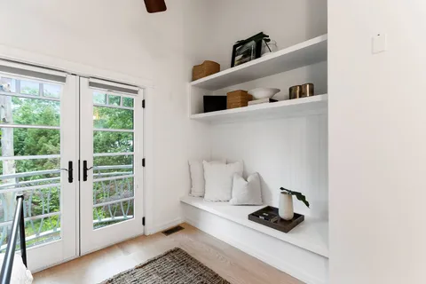 a white cabinet sitting next to a window