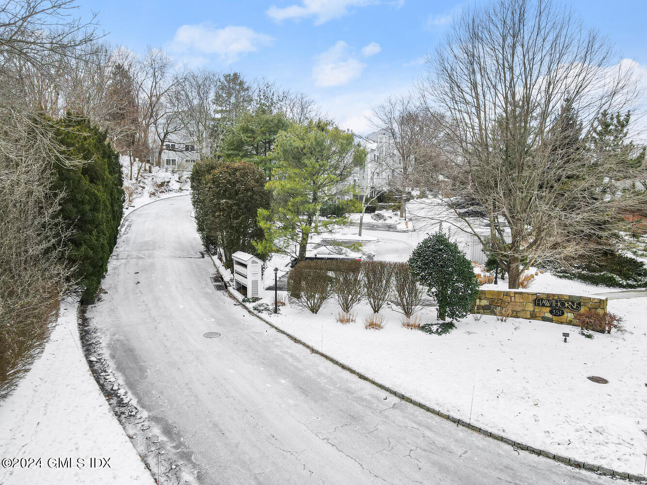 351 Pemberwick Road, Unit 915 Greenwich, CT 06831 - Photo 17 of 19 a view of a yard with snow on the road