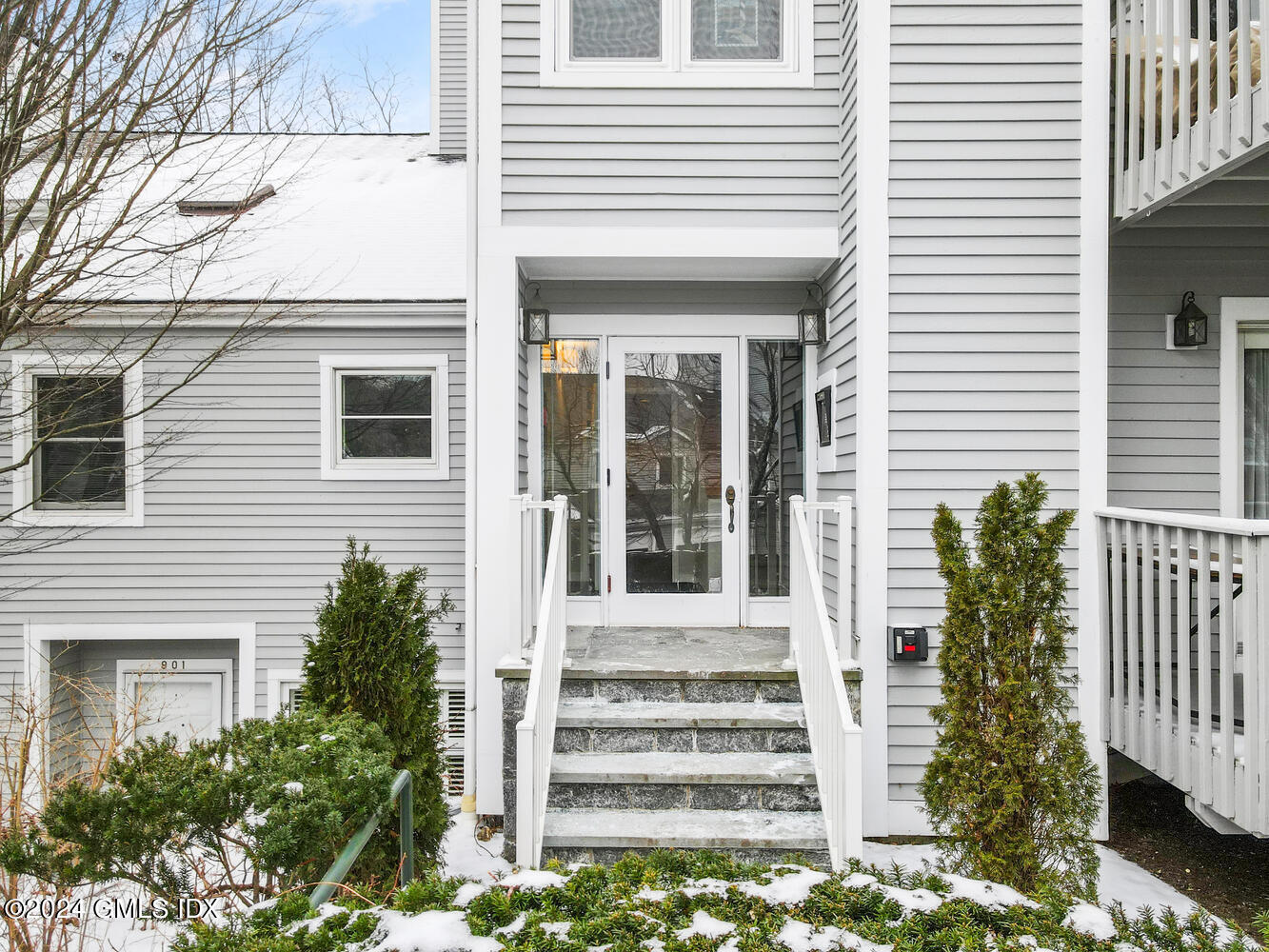 351 Pemberwick Road, Unit 915 Greenwich, CT 06831 - Photo 2 of 19 a front view of a house with a porch