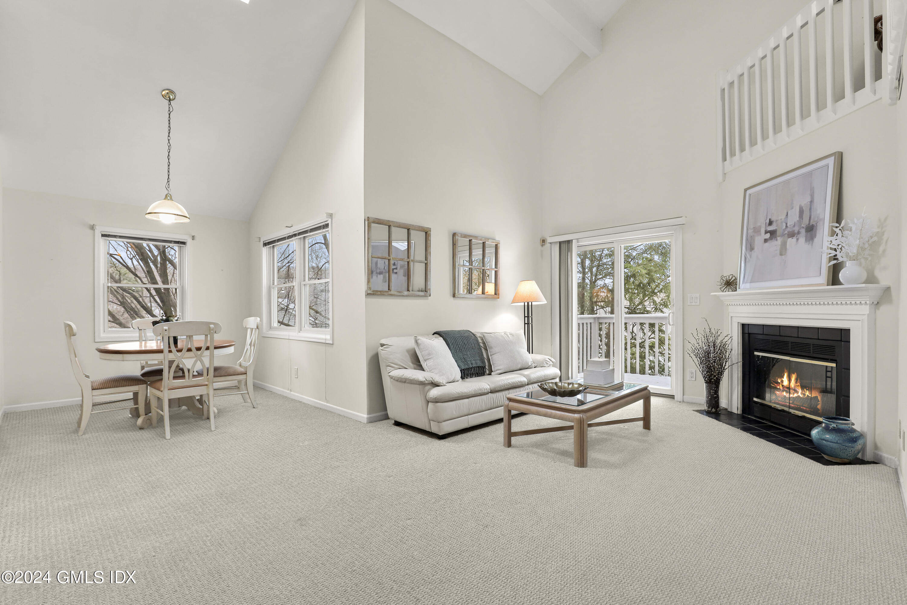 351 Pemberwick Road, Unit 915 Greenwich, CT 06831 - Photo 4 of 19 a living room with furniture and a fireplace