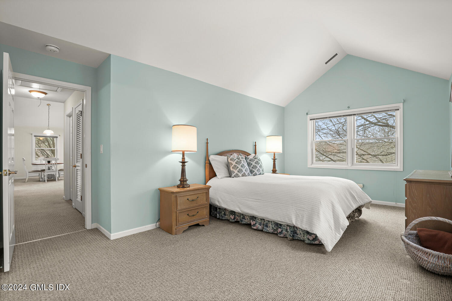 351 Pemberwick Road, Unit 915 Greenwich, CT 06831 - Photo 9 of 19 a spacious bedroom with a bed and a painting on the wall