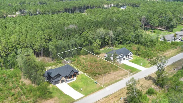 a view of a yard with chairs