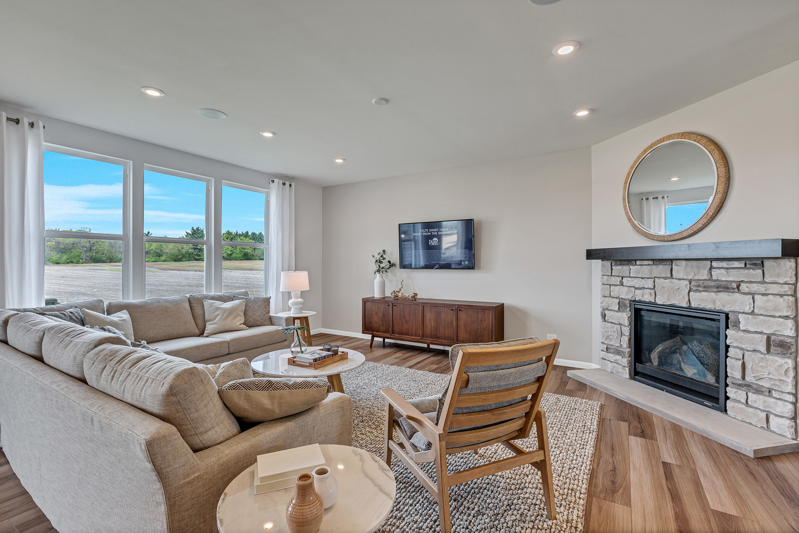 1702 Eastfield Drive Bartlett, IL 60103 - Photo 5 of 29 a living room with furniture a fireplace and a floor to ceiling window