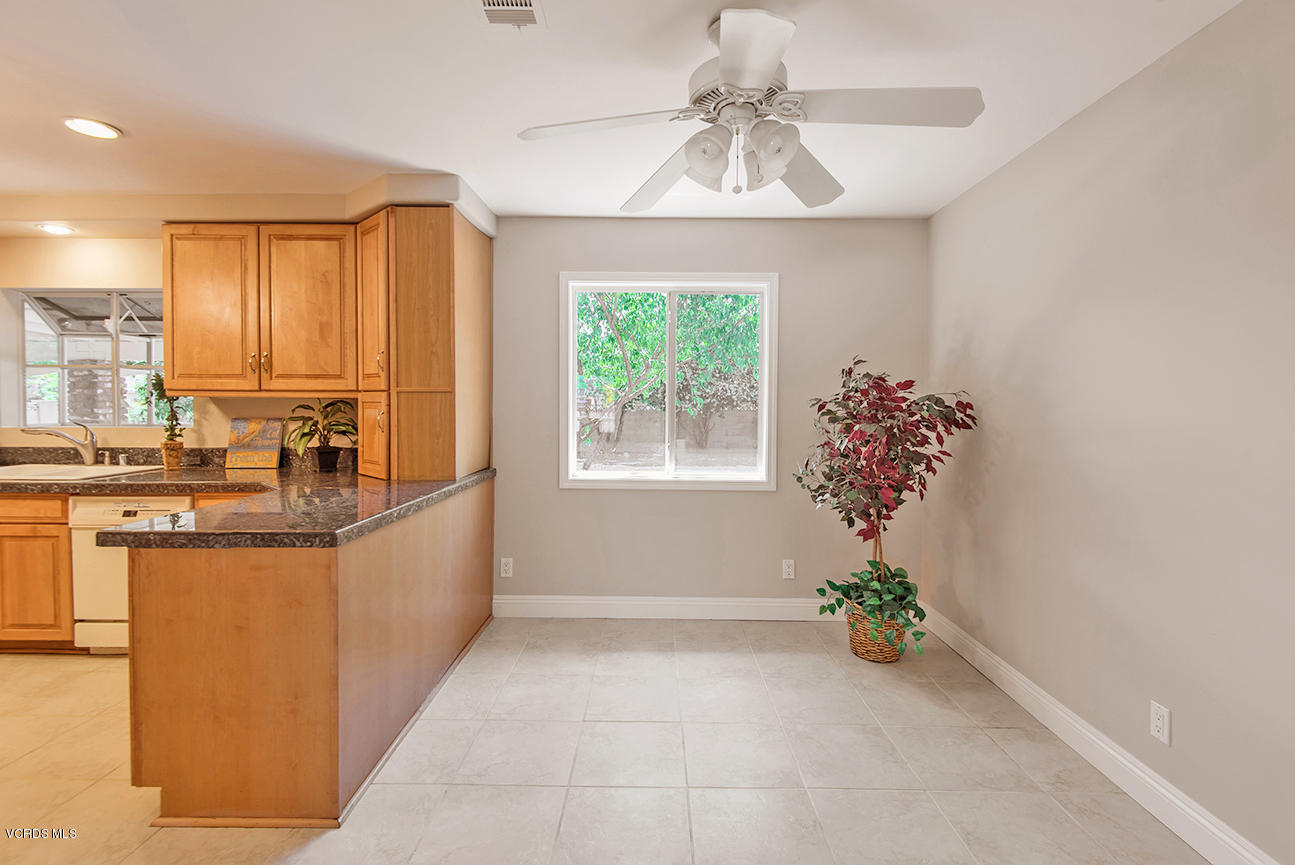 4204 Apricot Road Simi Valley, CA 93063 - Photo 7 of 20 a dining hall with granite countertop a stove a sink and dishwasher with a dining table