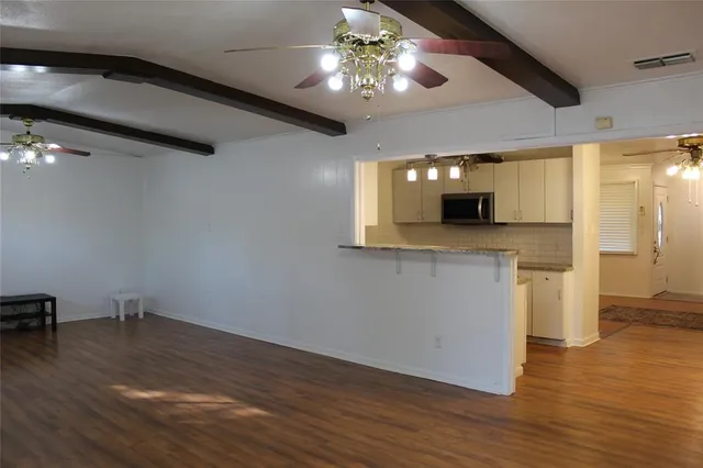 a view of a kitchen with a sink and a chandelier fan