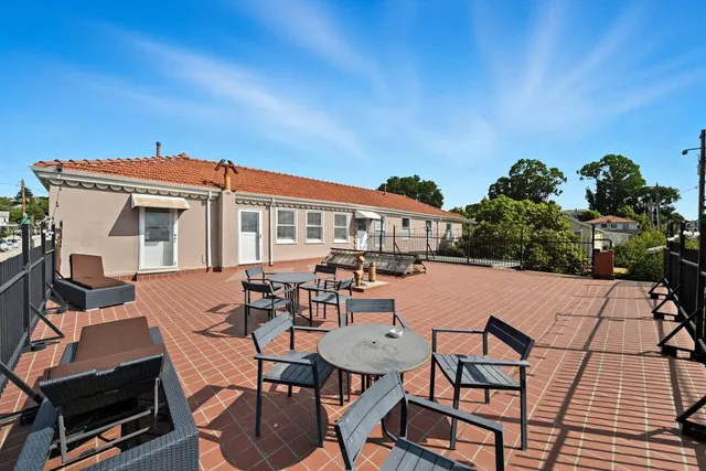 a backyard of a house with table and chairs