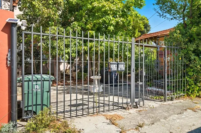 a view of a big room with wooden floor and windows