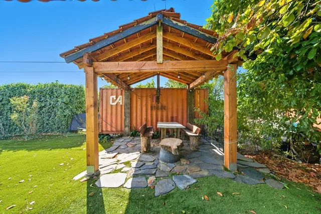a view of a room with wooden floor and a sink