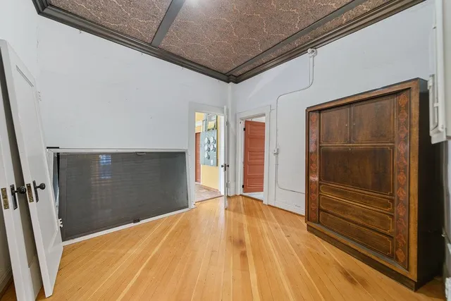 a view of a livingroom with wooden floor and a window