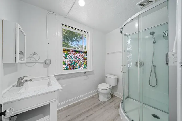 a view of empty room with wooden floor