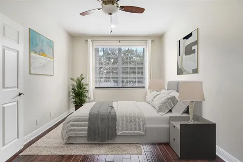 a bed sitting in a bedroom next to a window
