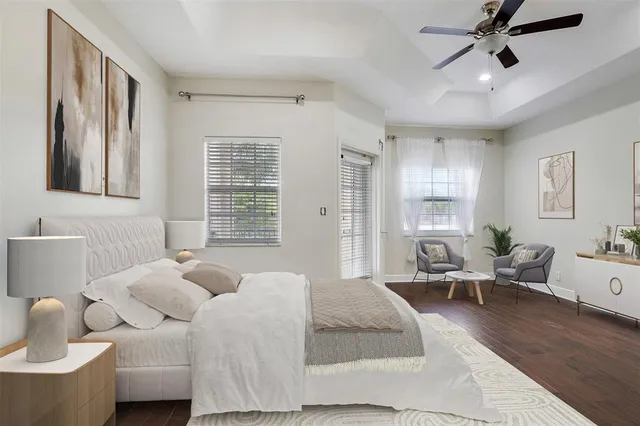 a spacious bedroom with a bed and wooden floor