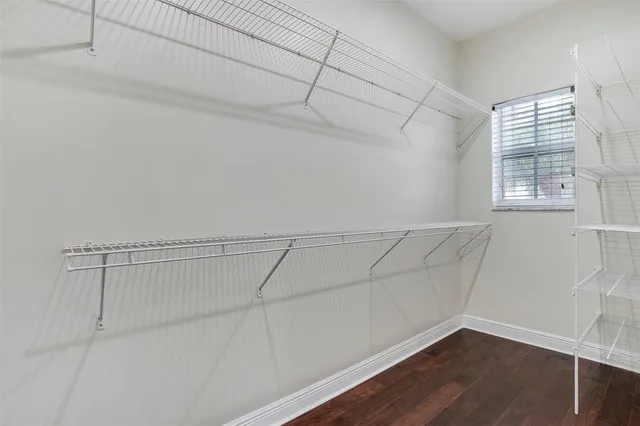 a view of a room with wooden floor and fan