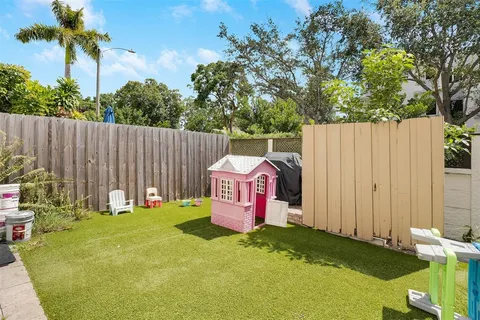 a backyard of a house with table and chairs