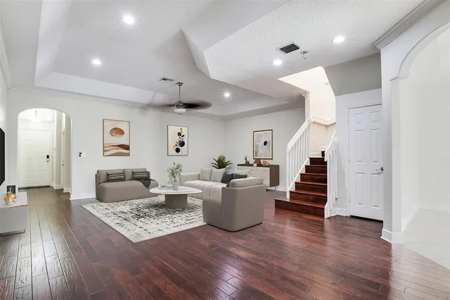 a living room with furniture and wooden floor