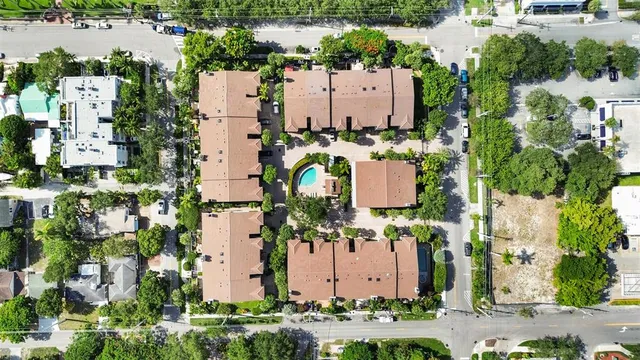 an aerial view of a house with a yard and seating space