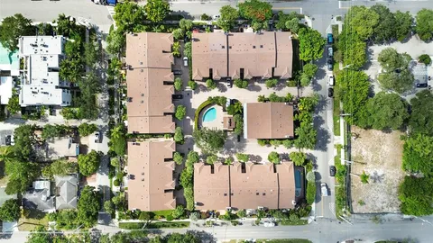 an aerial view of a residential apartment building with a garden and plants