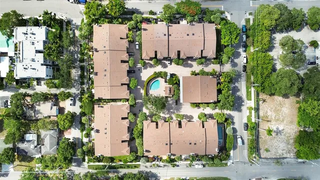 an aerial view of a residential apartment building with a garden and plants