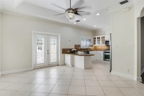 a large white kitchen with cabinets and a stove top oven