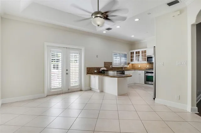 a large white kitchen with cabinets and a stove top oven