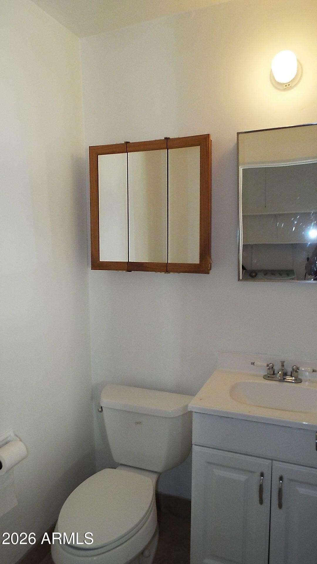 4331 North 20th Street Phoenix, AZ 85016 - Photo 11 of 13 a bathroom with a toilet a sink and mirror