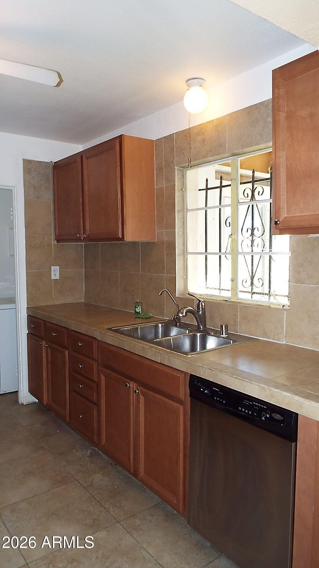 4331 North 20th Street Phoenix, AZ 85016 - Photo 5 of 13 a kitchen with a sink a window and cabinets